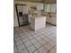 Bright kitchen featuring white cabinetry, stainless steel appliances, and a tile island for added workspace at 5316 Clover Blossom Ct, North Las Vegas, NV 89031