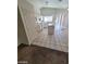 Open kitchen with white appliances, cabinets, tile island, and breakfast bar with natural light from the sliding doors at 5316 Clover Blossom Ct, North Las Vegas, NV 89031