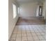 Bright living room with tile transitioning to carpet, illuminated by natural light at 5316 Clover Blossom Ct, North Las Vegas, NV 89031