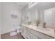 Bright bathroom featuring double sinks, granite counters, and modern finishes at 5662 Escamilla Rd, Las Vegas, NV 89135