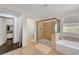 Bathroom featuring a glass shower, soaking tub, tiled floor, and walk-in closet at 5662 Escamilla Rd, Las Vegas, NV 89135