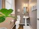 Cozy half bathroom with modern fixtures, pedestal sink, and stylish décor at 5662 Escamilla Rd, Las Vegas, NV 89135