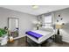 Bedroom featuring a bed, wood floors, full-length mirror, and natural light at 5662 Escamilla Rd, Las Vegas, NV 89135