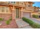 Charming two-story home with neutral paint, stone accents, a two-car garage, and manicured landscaping at 5662 Escamilla Rd, Las Vegas, NV 89135