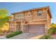 Charming two-story home with neutral paint, stone accents, a two-car garage, and manicured landscaping at 5662 Escamilla Rd, Las Vegas, NV 89135