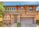 Charming two-story home with neutral paint, stone accents, a two-car garage, and manicured landscaping at 5662 Escamilla Rd, Las Vegas, NV 89135