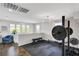 Bright home gym featuring workout equipment, modern lighting, and hardwood floors at 5662 Escamilla Rd, Las Vegas, NV 89135