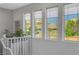 Upstairs hallway with hardwood floors and natural light showcases mountain views at 5662 Escamilla Rd, Las Vegas, NV 89135