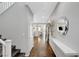 Inviting hallway with dark wood floors and a decorative mirror leading to other rooms at 5662 Escamilla Rd, Las Vegas, NV 89135
