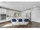 Modern kitchen features white cabinets, stainless steel appliances, granite countertops, and a large island at 5662 Escamilla Rd, Las Vegas, NV 89135
