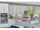 Bright kitchen boasts white cabinets, stainless appliances and an island with granite countertops at 5662 Escamilla Rd, Las Vegas, NV 89135