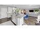 Open concept kitchen with granite counters, stainless appliances, and island with breakfast bar at 5662 Escamilla Rd, Las Vegas, NV 89135