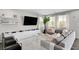 Spacious living room featuring a large TV, console, and comfortable seating at 5662 Escamilla Rd, Las Vegas, NV 89135
