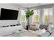 Bright living room featuring a large TV, console, and comfortable sofa at 5662 Escamilla Rd, Las Vegas, NV 89135