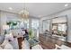 Bright living room features a modern chandelier, hardwood floors, and large decorative mirrors at 5662 Escamilla Rd, Las Vegas, NV 89135