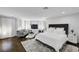 Spacious main bedroom with seating area, hardwood floors, natural light, and neutral tones at 5662 Escamilla Rd, Las Vegas, NV 89135