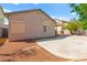 Backyard featuring rock landscaping, partial concrete patio, and sun shades on windows at 5752 Shermer Ct, Las Vegas, NV 89120