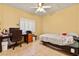 Bedroom features a large window, desk and ceiling fan at 5752 Shermer Ct, Las Vegas, NV 89120