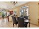 Bright dining area featuring tile floors, a chandelier, and kitchen with stainless appliances in background at 5752 Shermer Ct, Las Vegas, NV 89120