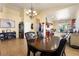 Open dining area with dark wood table and leather chairs, with view to the kitchen at 5752 Shermer Ct, Las Vegas, NV 89120