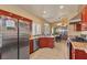 View of stainless steel refrigerator and spacious kitchen with tile flooring and granite countertops at 5752 Shermer Ct, Las Vegas, NV 89120