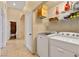 Laundry room with machines, wire shelves and tile floor at 5752 Shermer Ct, Las Vegas, NV 89120