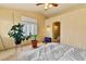 Cozy main bedroom with tile floor, ceiling fan, and natural light through the shuttered window at 5752 Shermer Ct, Las Vegas, NV 89120