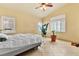 Bright main bedroom with tile flooring, ceiling fan, and natural light from shuttered windows at 5752 Shermer Ct, Las Vegas, NV 89120