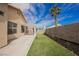 Beautiful backyard features a small lawn, patio area, and desert landscaping under a clear sky at 5828 Red Gull St, Las Vegas, NV 89149
