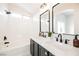 Bathroom with double vanity, black fixtures, and a shower-over-tub at 5828 Red Gull St, Las Vegas, NV 89149