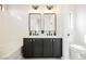 Bathroom features dual sinks, stylish mirrors, and updated fixtures at 5828 Red Gull St, Las Vegas, NV 89149