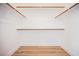 Walk-in closet with wood-style flooring and wooden closet rods at 5828 Red Gull St, Las Vegas, NV 89149