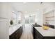 Bright open kitchen boasts white cabinets, dark island, and stainless steel appliances at 5828 Red Gull St, Las Vegas, NV 89149