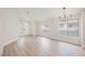 Spacious living room with great natural light, high ceilings, and modern chandelier at 5828 Red Gull St, Las Vegas, NV 89149
