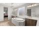 Bathroom with modern finishes including dual sink vanity, soaking tub, and wood-look tile floors at 5860 Noah Springs Ct, Las Vegas, NV 89149