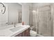 Bathroom featuring a modern vanity with stone countertop, a framed mirror, and tiled shower at 5860 Noah Springs Ct, Las Vegas, NV 89149