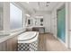 Bright bathroom features a soaking tub, a dual sink vanity, and a tiled shower with glass door at 5860 Noah Springs Ct, Las Vegas, NV 89149