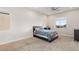 Neutral bedroom with carpeted floor, large windows, and a ceiling fan at 5860 Noah Springs Ct, Las Vegas, NV 89149