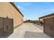 Exterior shot of driveway, backyard, and gate leading to the main home at 5860 Noah Springs Ct, Las Vegas, NV 89149