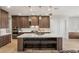 Well-equipped kitchen with a central island, designer lighting, and modern appliances at 5860 Noah Springs Ct, Las Vegas, NV 89149