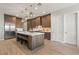 Stylish kitchen featuring a large island with seating, wood cabinetry, and stainless appliances at 5860 Noah Springs Ct, Las Vegas, NV 89149