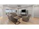 Bright and airy living room featuring comfortable seating, a ceiling fan, and backyard views at 5860 Noah Springs Ct, Las Vegas, NV 89149