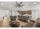 Spacious living room featuring modern furniture and a large ceiling fan at 5860 Noah Springs Ct, Las Vegas, NV 89149