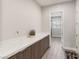 Mud room with quartz countertops, wood cabinets, and wood-look floors at 5860 Noah Springs Ct, Las Vegas, NV 89149