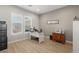 Bright home office with wood-look floors, grey walls, and large window with shutters at 5860 Noah Springs Ct, Las Vegas, NV 89149