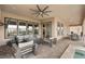 Covered patio with outdoor seating, ceiling fan, and outdoor kitchen at 5860 Noah Springs Ct, Las Vegas, NV 89149