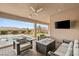 Covered patio with outdoor seating, ceiling fan, and view of pool and backyard at 5860 Noah Springs Ct, Las Vegas, NV 89149