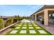 Backyard pool features artificial turf, stepping stones, covered patio, and professional landscaping at 5860 Noah Springs Ct, Las Vegas, NV 89149