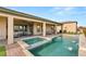 Backyard pool with covered patio and outdoor seating at 5860 Noah Springs Ct, Las Vegas, NV 89149