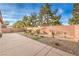 Backyard view with a block wall, gravel, some landscaping, and a small patch of artificial turf at 6128 Forest Pony Ave, Las Vegas, NV 89122
